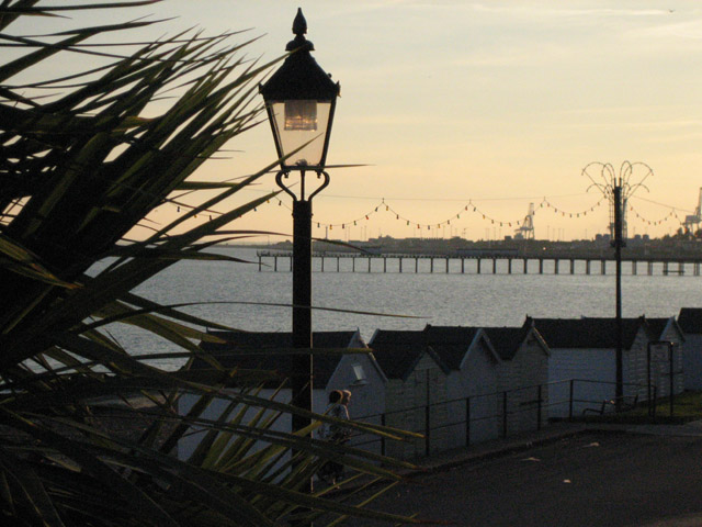 Edwardian style street lamp with the beach in the background at sunset