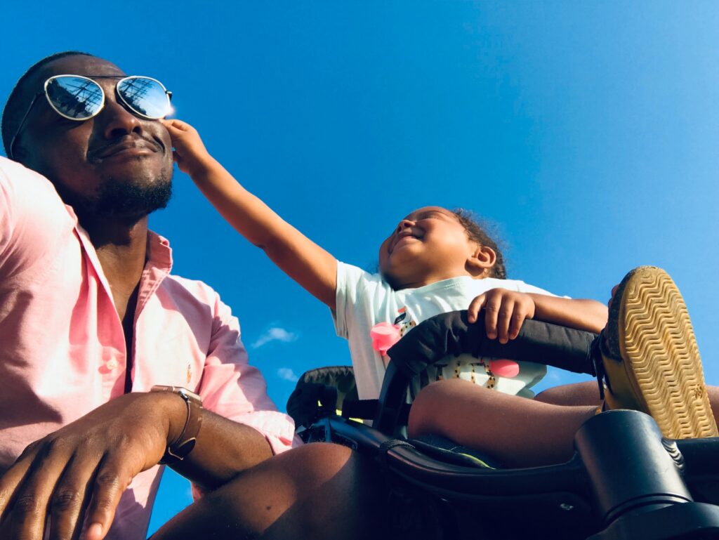 Father and child in buggy laughing and smiling